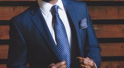 man wearing sleek navy suit and tie